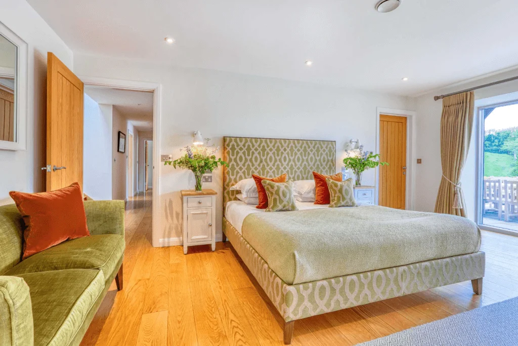 Bright elegant bedroom with green accents and balcony view