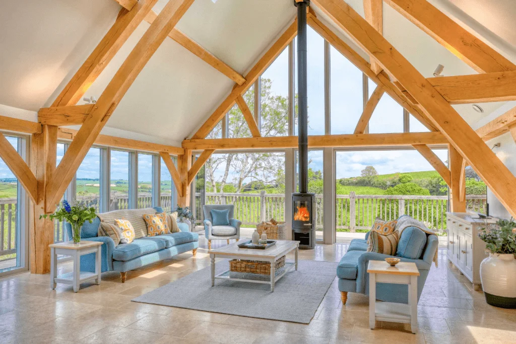 Bright sunroom with exposed beams and countryside view