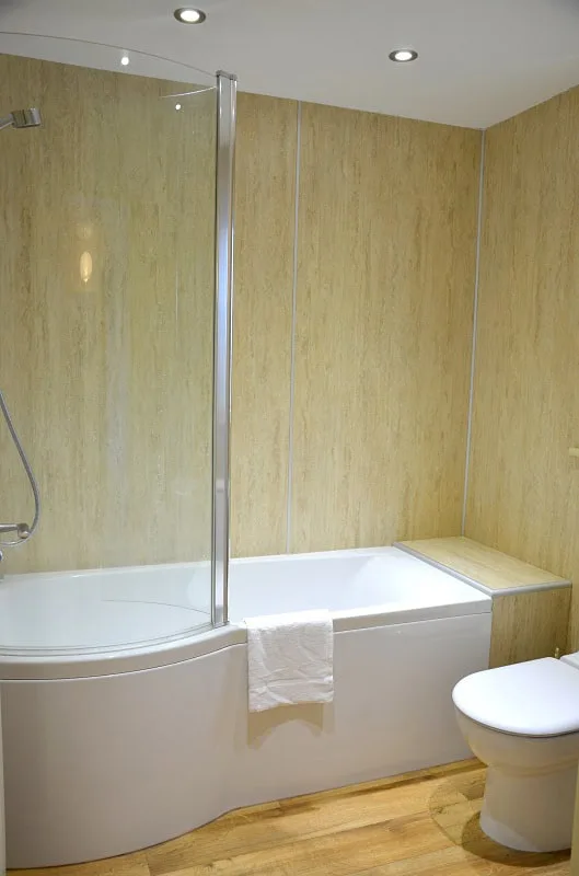 Modern bathroom with enclosed bathtub and wooden panels