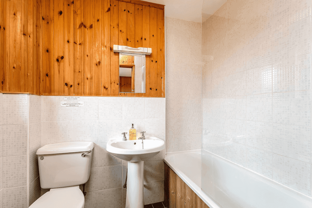 Bright bathroom with wooden cabinets and white fixtures