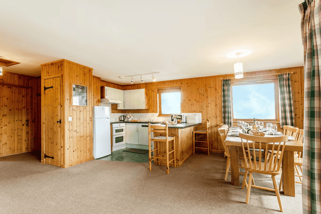 Cozy wooden cabin kitchen and dining area with sunlight