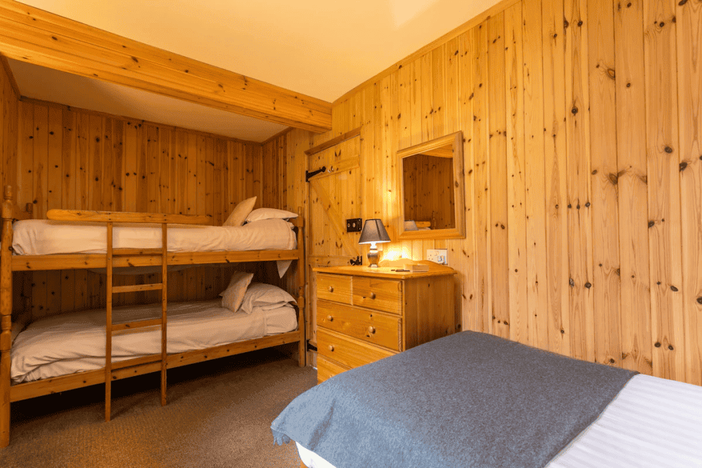 Cozy wooden cabin bedroom with bunk beds