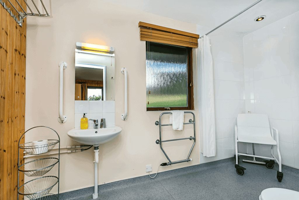 Accessible bathroom with grab bars and shower seat