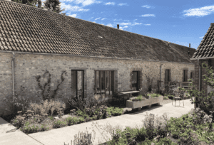 Restored stone farmhouse with patio and lush garden