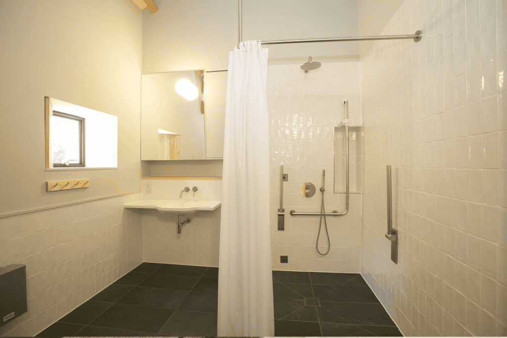Minimalist bathroom with shower, sink, and mirror