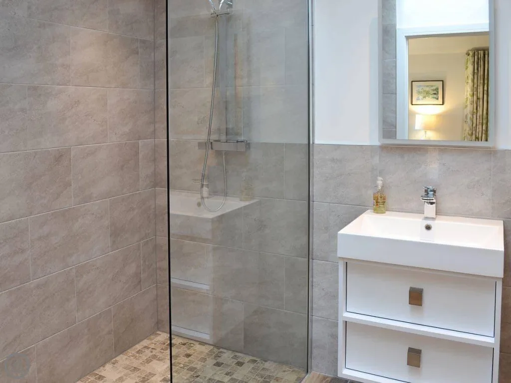 Modern bathroom with glass shower and white vanity