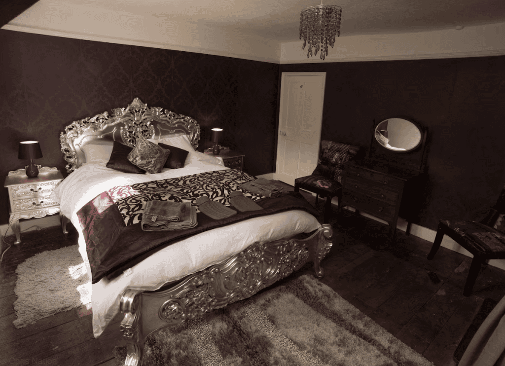 Elegant vintage bedroom with ornate silver bed frame