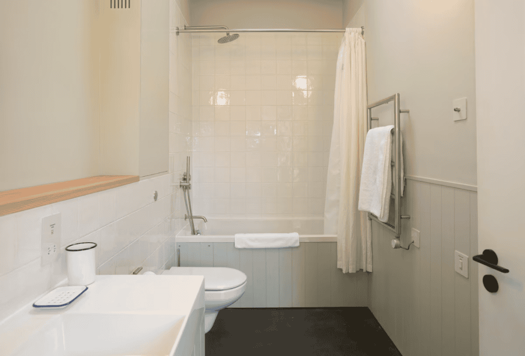 White modern bathroom with shower and towels