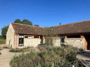 Renovated barn with garden on sunny day