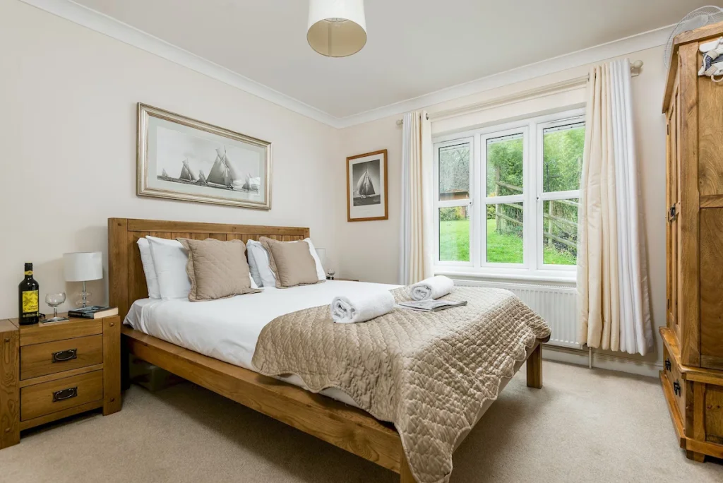 Spacious bedroom with wooden furniture and garden view