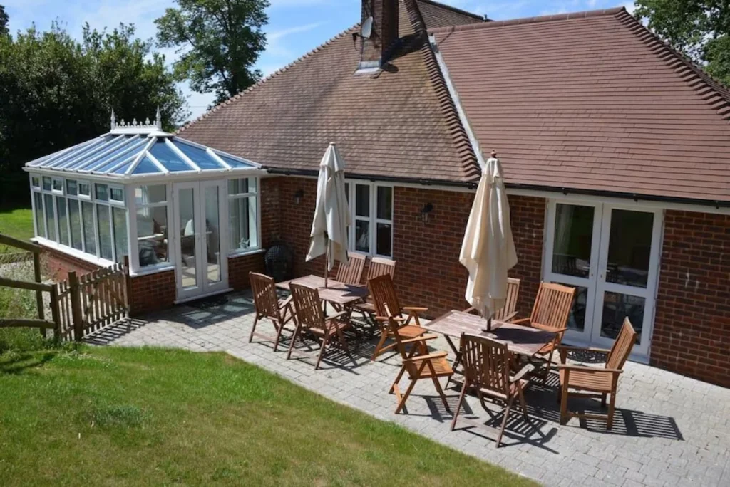 Brick house with conservatory and outdoor dining area