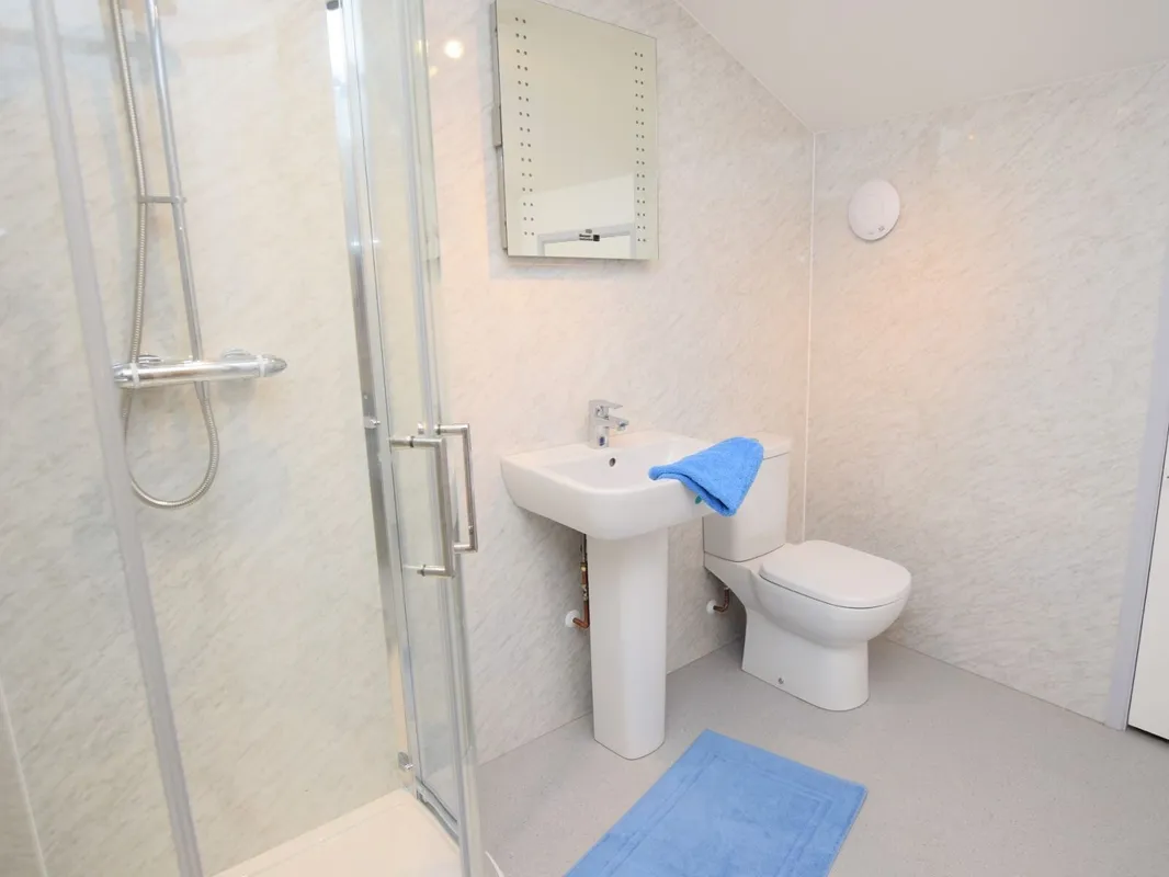 Modern bathroom with shower, sink, and toilet