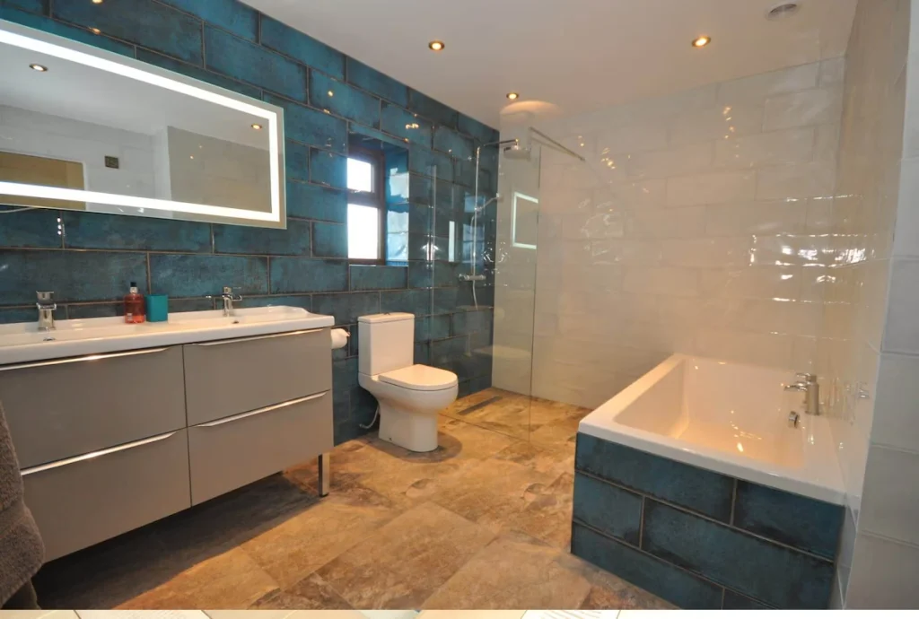 Modern bathroom with blue tiles and white fixtures