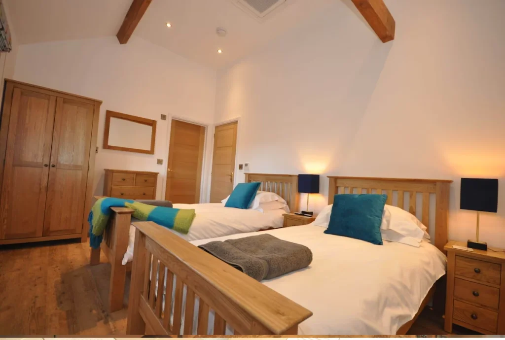 Cozy twin bedroom with wooden furniture and blue accents