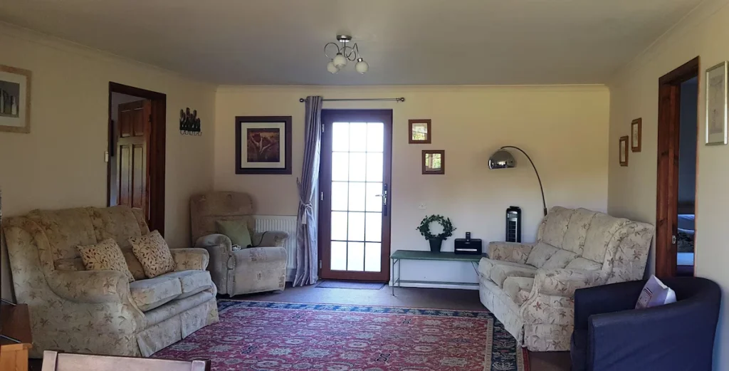 Spacious living room with sofas and floral patterns