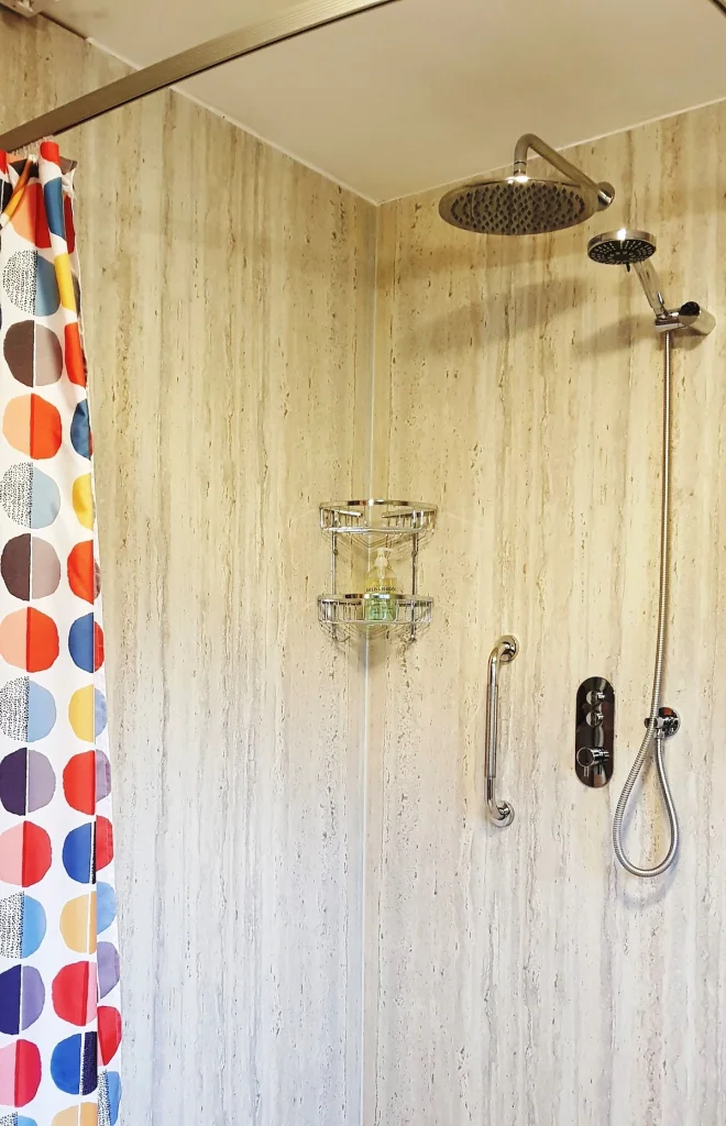 Colorful shower curtain in modern bathroom with rainfall showerhead