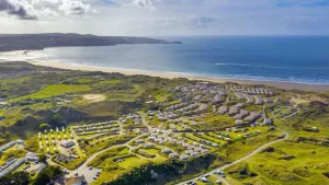 Aerial view of coastal caravan park in lush landscape