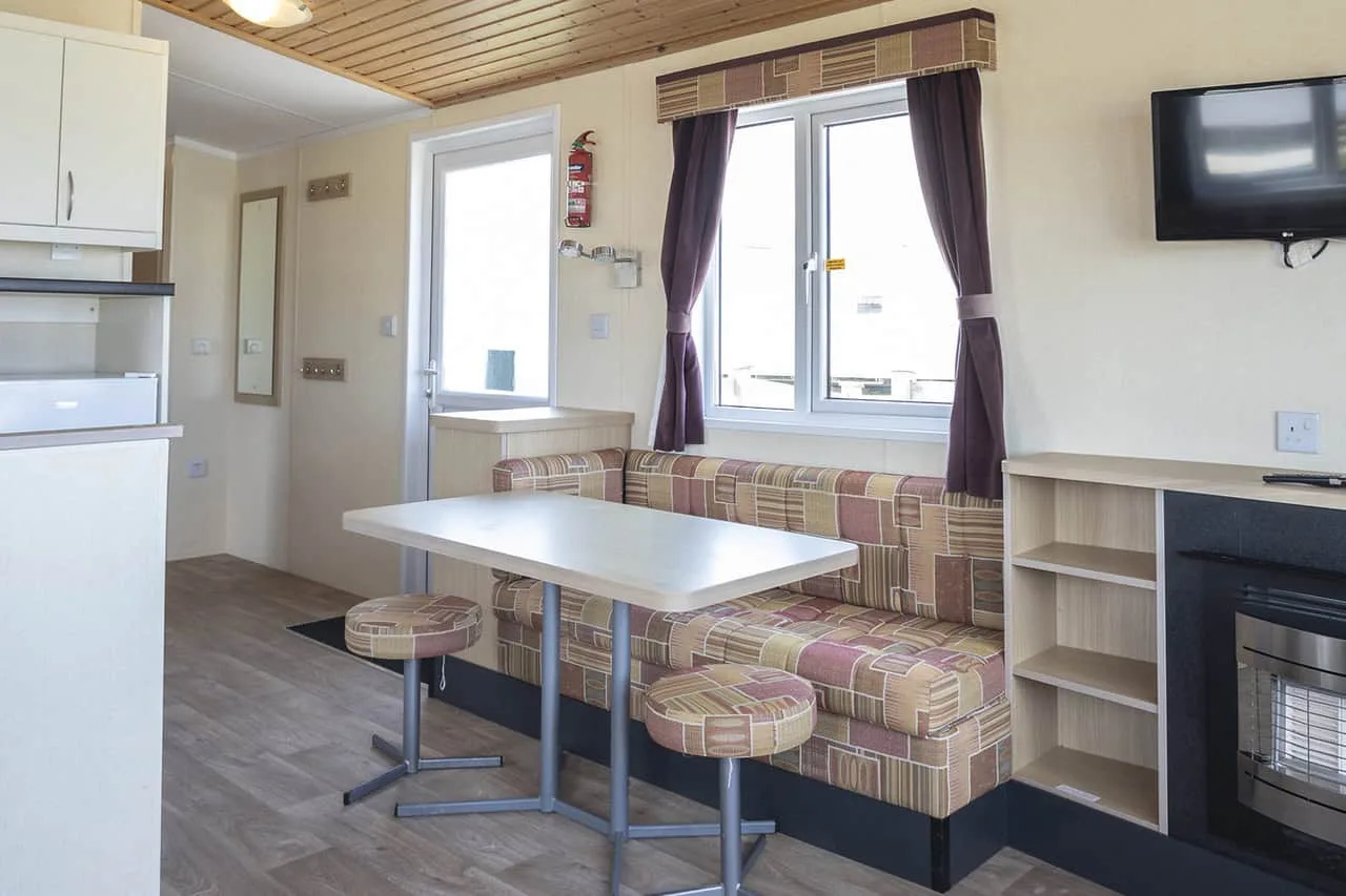 Compact modern kitchenette with dining area and fireplace