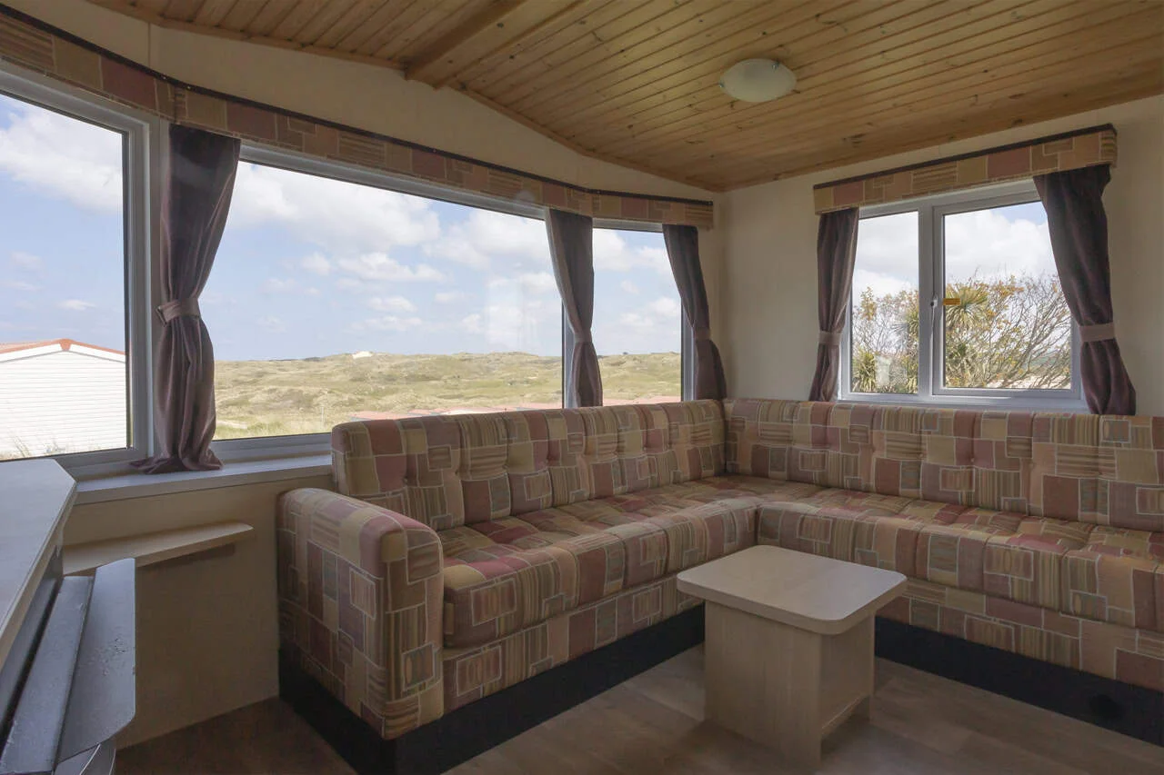 Cozy sunlit nook with couches and dune view