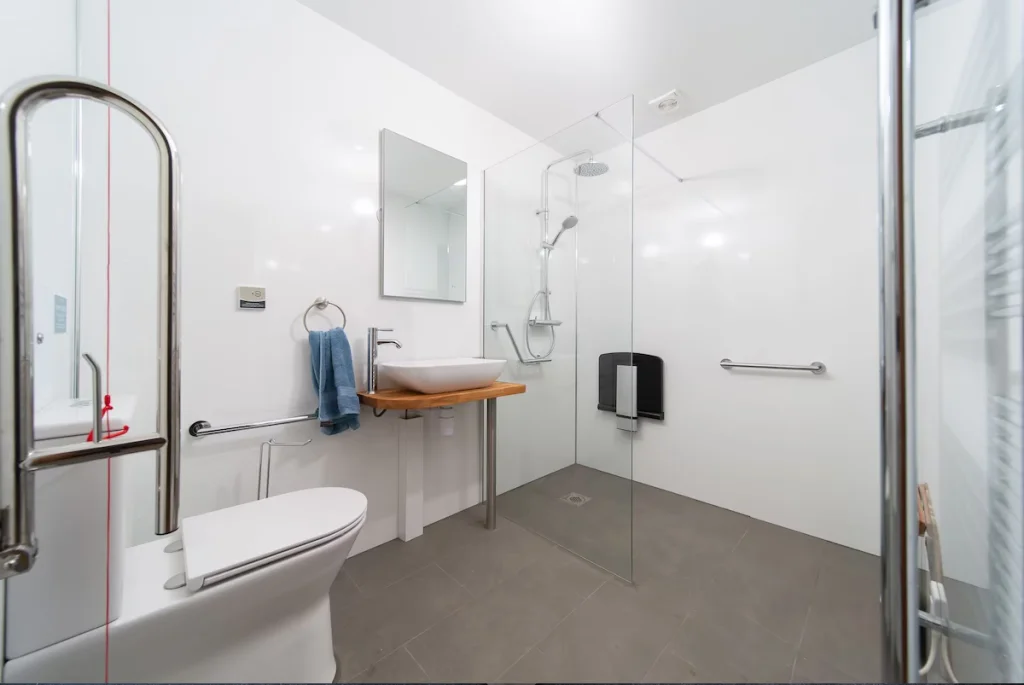 Modern bathroom with accessible features and glass shower