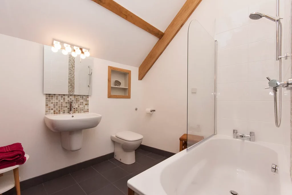 Modern bathroom with bathtub and wooden beams