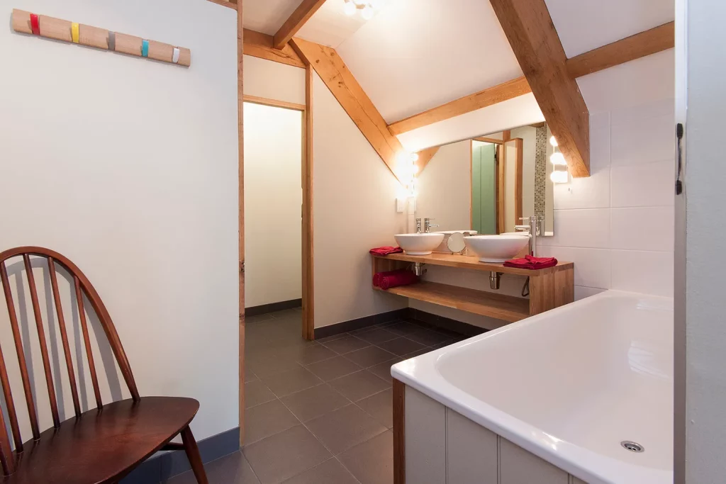 Modern bathroom with wooden beams and dual sinks
