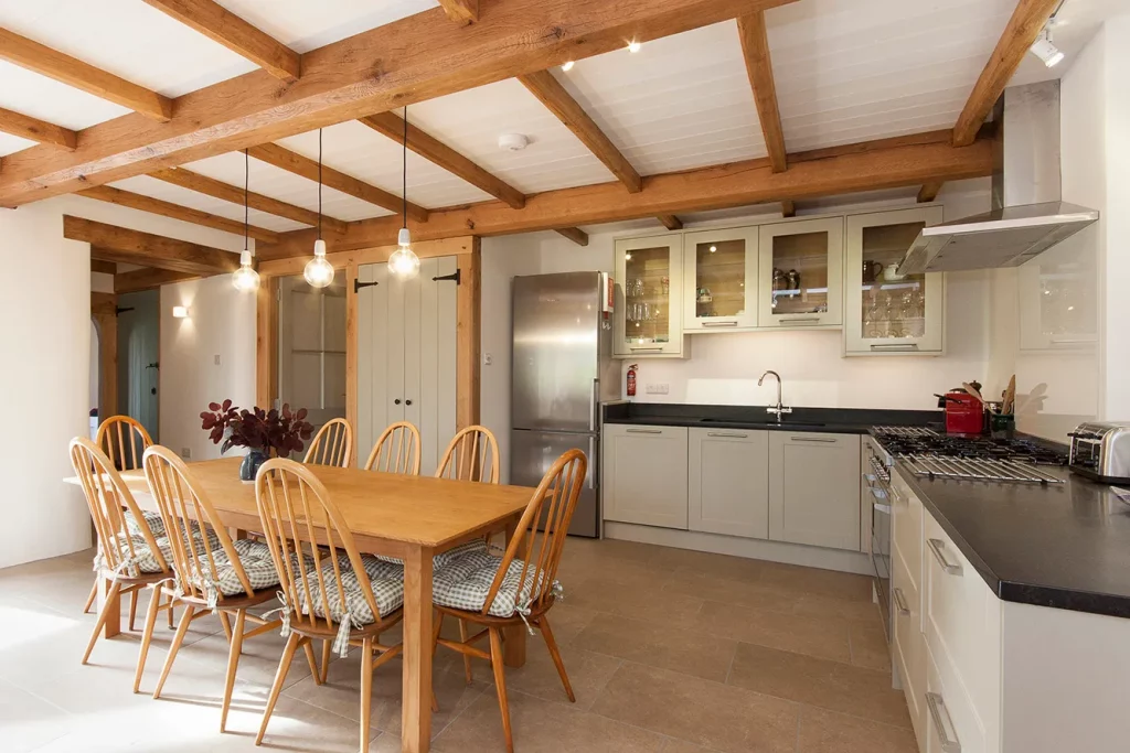Spacious kitchen with wooden beams and dining area