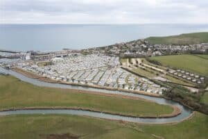 Aerial view of coastal town with marina and meandering river