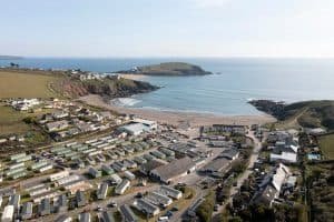 Aerial view of coastal village with beach and caravan park