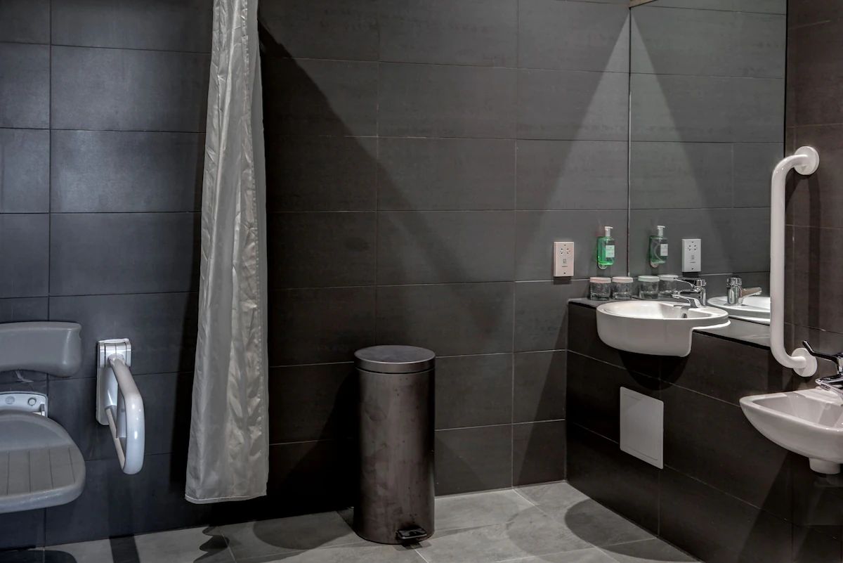 Modern bathroom with grey tiles and accessible fixtures