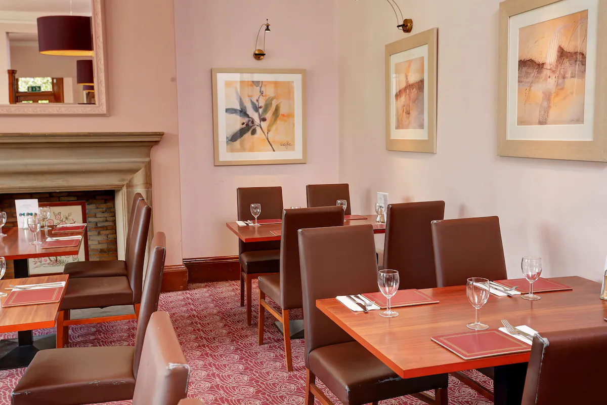 Elegant restaurant interior with set tables and artwork