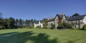 Large traditional house surrounded by lush green lawn