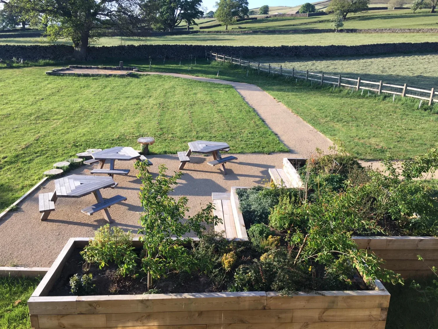 Outdoor park with picnic tables and greenery