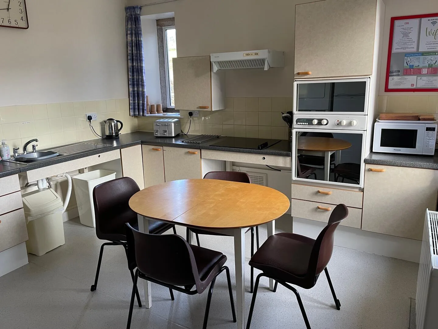 Modern kitchen with round table and appliances