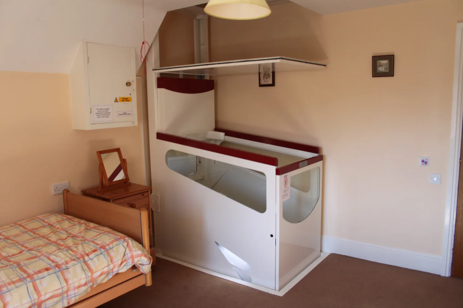 Compact bedroom with vertical folding bed and small desk