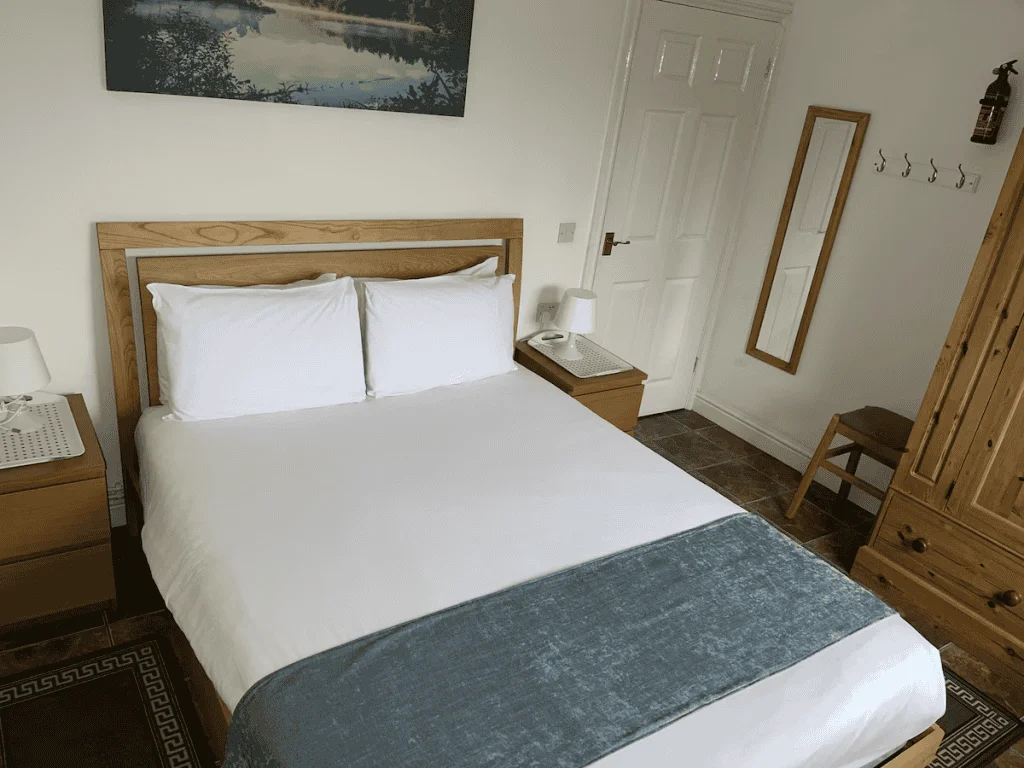 Cozy hotel room with wooden furniture and scenic art