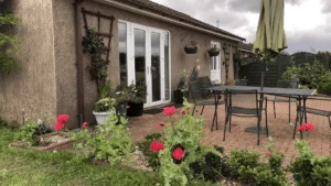 Cozy garden patio with flowers and outdoor furniture