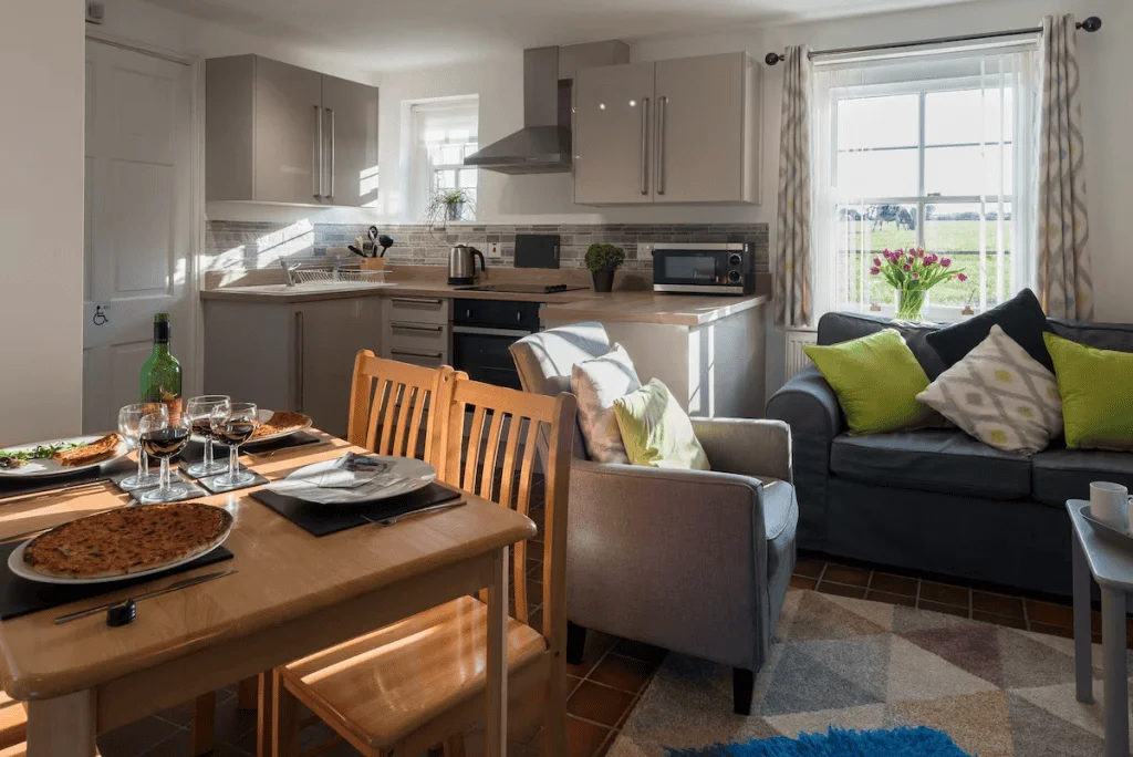 Modern kitchen with dinner setup and cozy living area
