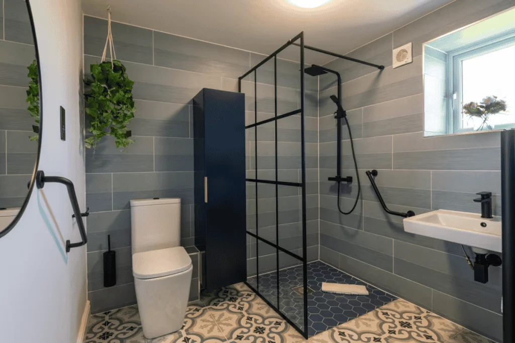 Modern bathroom with grey tiles and black shower frame