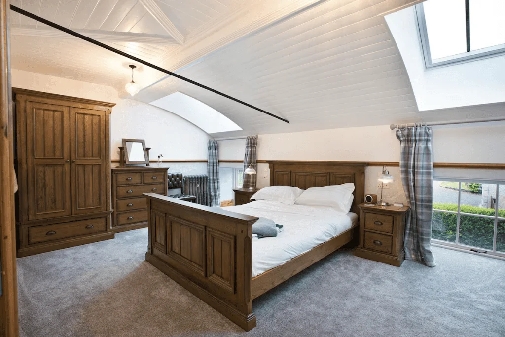 Spacious bedroom with wooden furniture and vaulted ceiling
