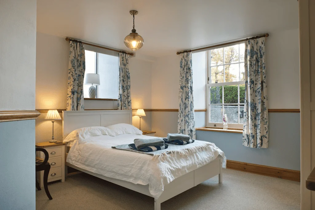 Cozy bedroom with floral curtains and elegant lighting