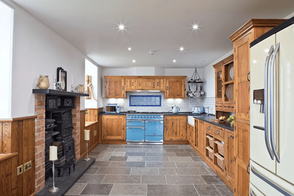 Spacious kitchen with wooden cabinets and blue stove