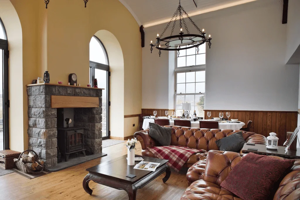 Elegant living room with stone fireplace and arched windows