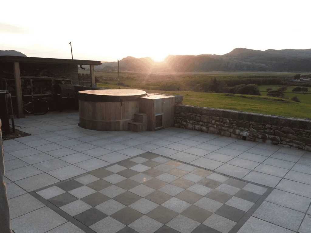 Sunset behind mountains, viewed from a tiled patio