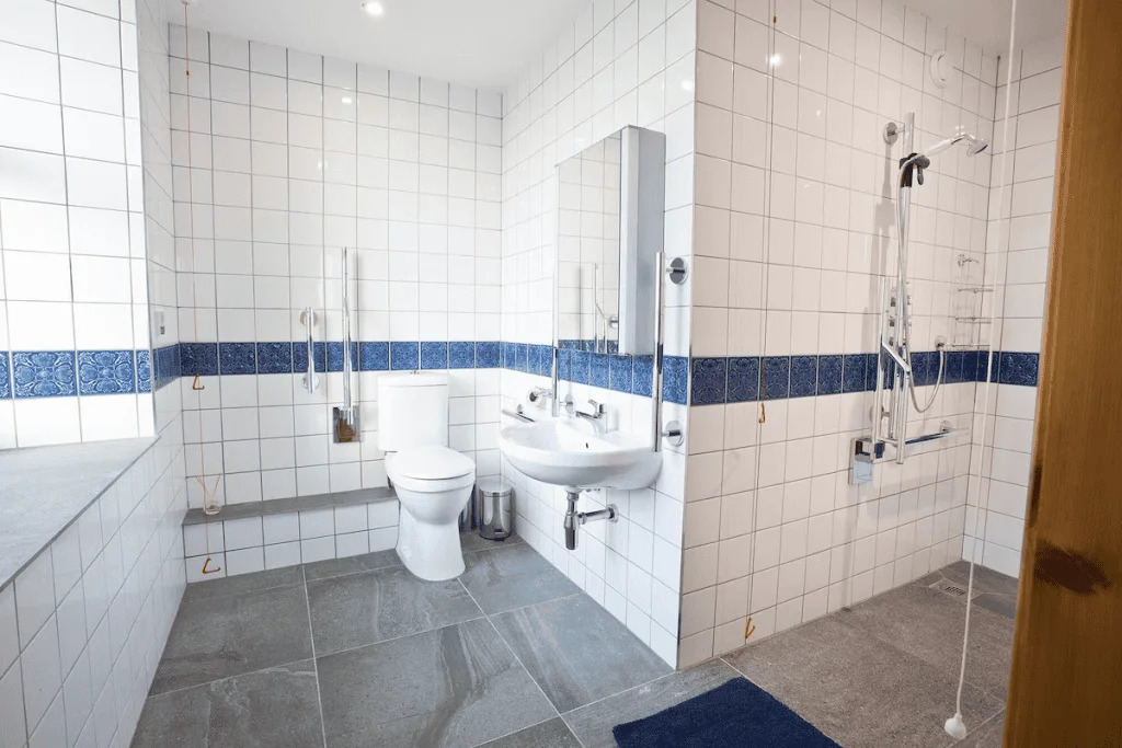 Spacious bathroom with white and blue tiles, modern fixtures