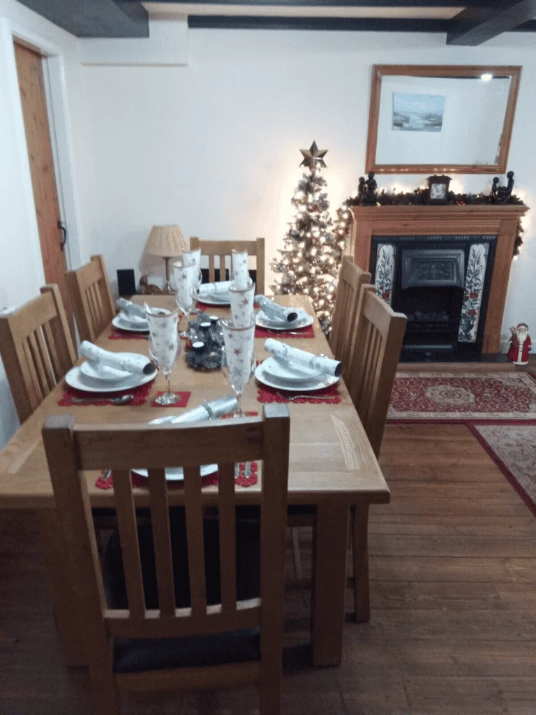 Cozy dining room decorated for Christmas with lit tree