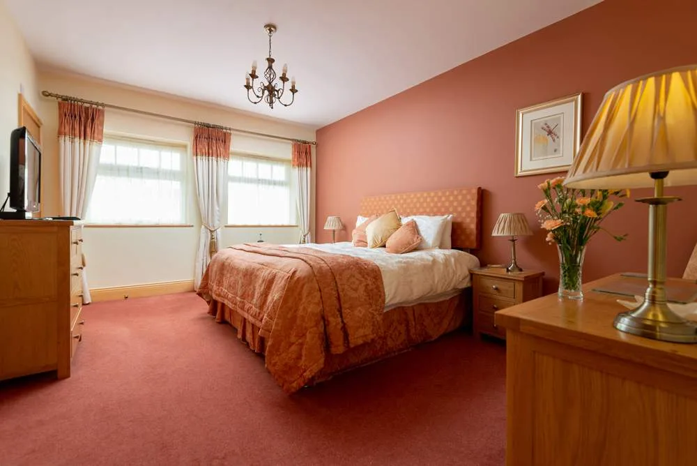 Elegant peach-toned bedroom with natural light