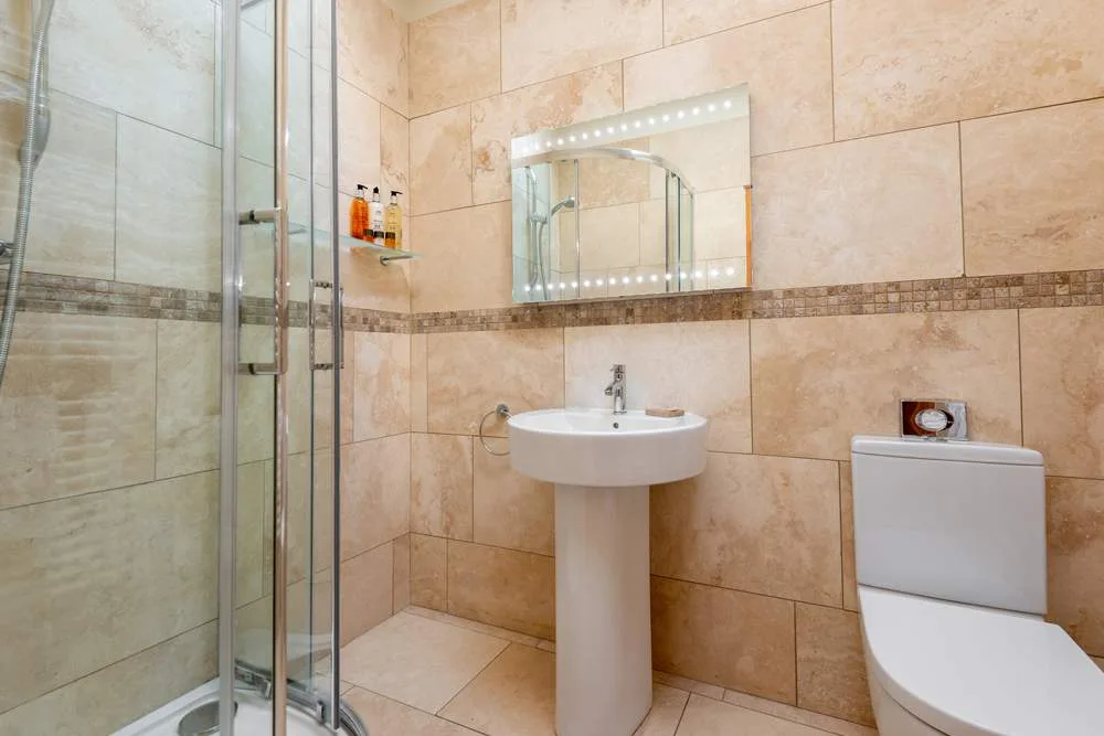 Modern bathroom with shower and beige tiles