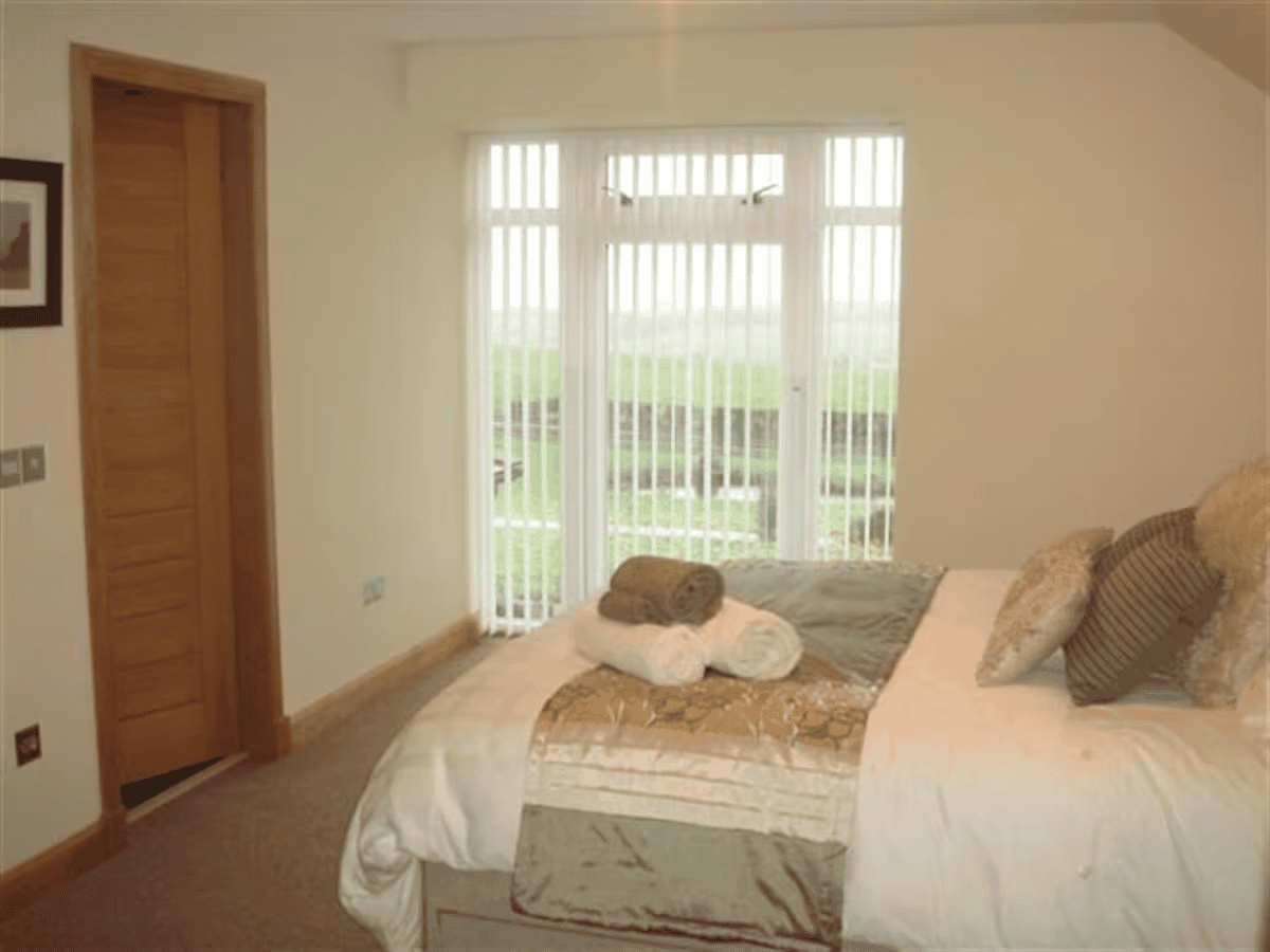 Cozy bedroom with large window and garden view