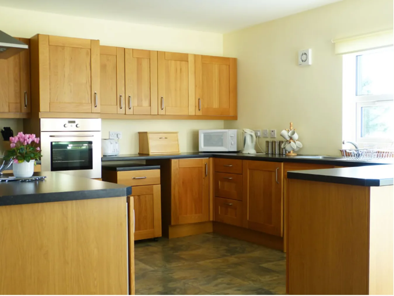 Spacious kitchen with wooden cabinets and modern appliances